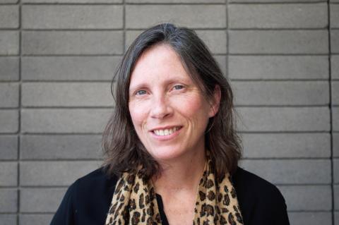 Kimberly Johnson wearing a leopard-print scarf and a black shirt.